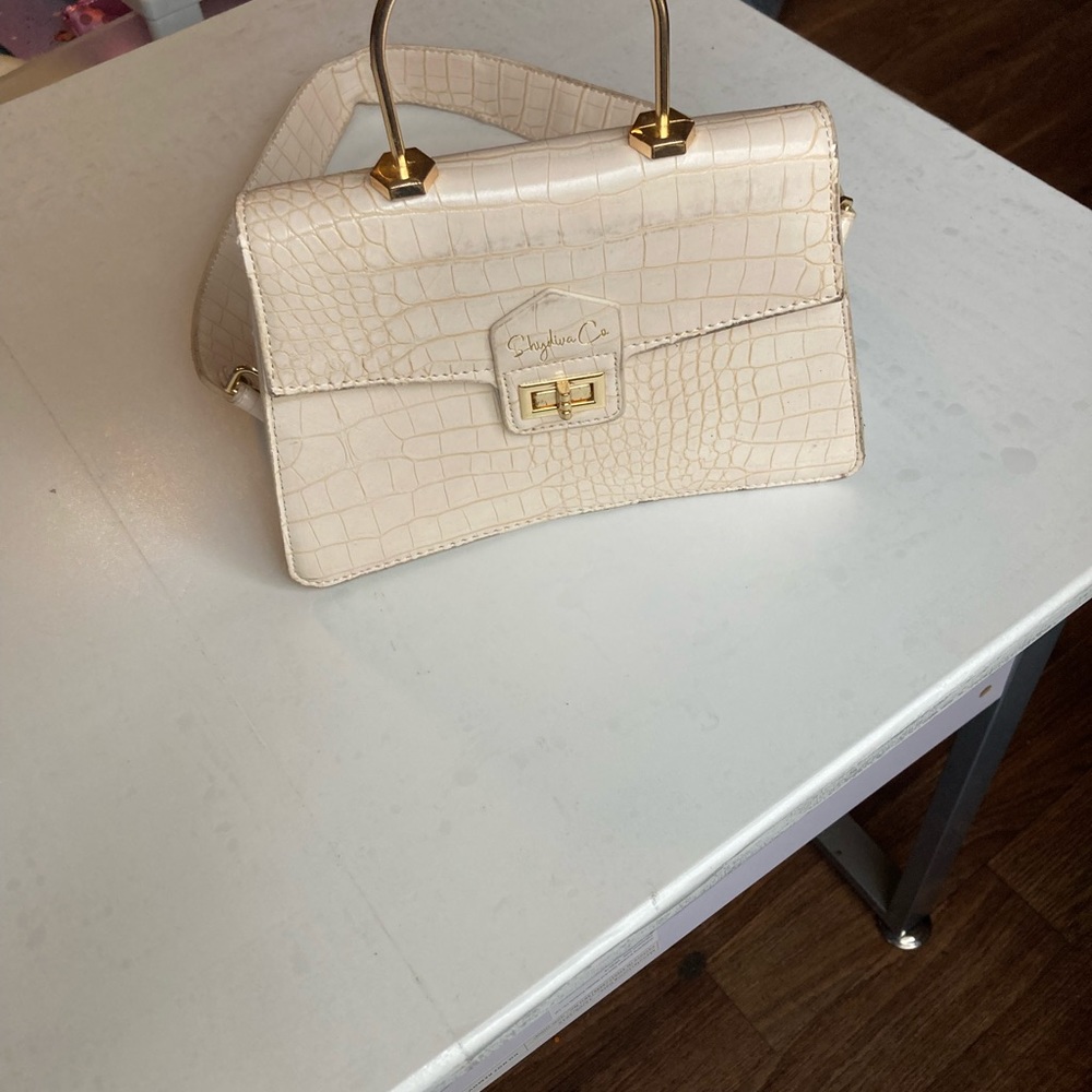 mini cream bag with gold accents